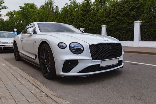 White brand new luxury sport cat Bentley Continental GT 2018 coupe on the streets of European city