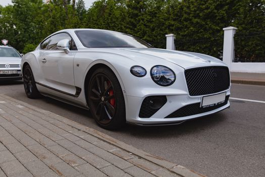 White brand new luxury sport cat Bentley Continental GT 2018 coupe on the streets of European city