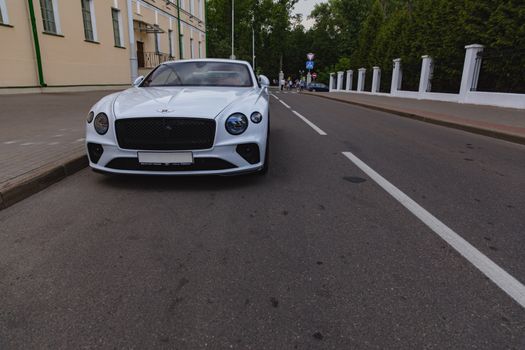 White brand new luxury sport cat Bentley Continental GT 2018 coupe on the streets of European city