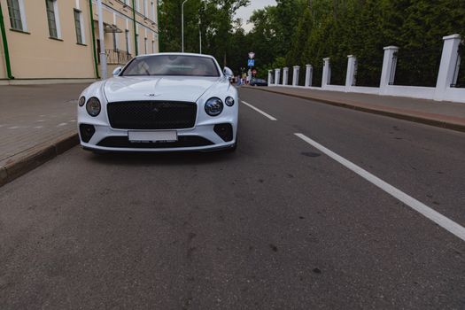 White brand new luxury sport cat Bentley Continental GT 2018 coupe on the streets of European city