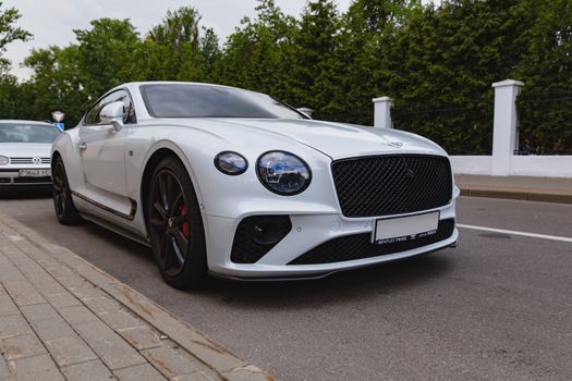 White brand new luxury sport cat Bentley Continental GT 2018 coupe on the streets of European city