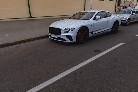 White brand new luxury sport cat Bentley Continental GT 2018 coupe on the streets of European city