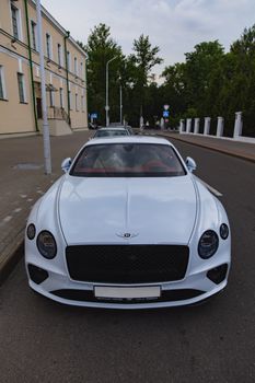 White brand new luxury sport cat Bentley Continental GT 2018 coupe on the streets of European city