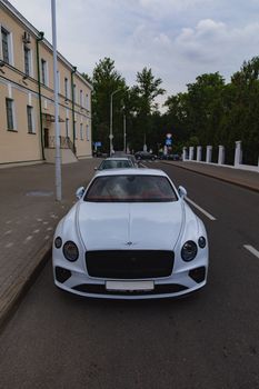 White brand new luxury sport cat Bentley Continental GT 2018 coupe on the streets of European city