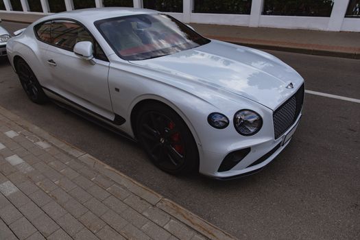 White brand new luxury sport cat Bentley Continental GT 2018 coupe on the streets of European city