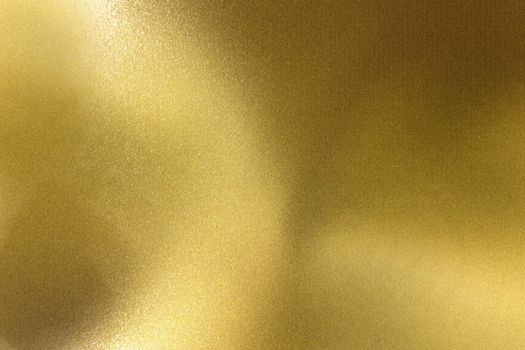 Light shining on brushed golden wave metal wall, abstract texture background