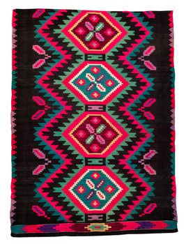 Colorful vintage handmade rug with geometrical shapes and motifs traditional of Maramures region of Romania isolated on a white background.