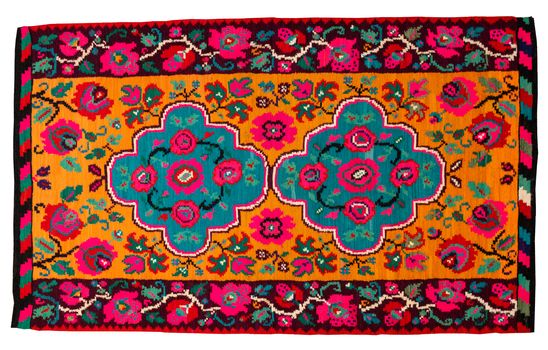 Colorful vintage handmade rug with geometrical shapes and motifs traditional of Maramures region of Romania isolated on a white background.