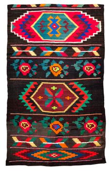 Colorful vintage handmade rug with geometrical shapes and motifs traditional of Maramures region of Romania isolated on a white background.