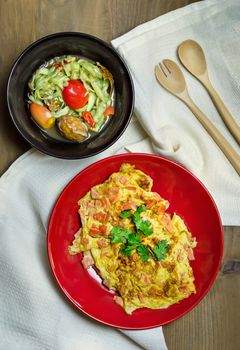 top view of fried egg and spicy cucumber salad , Thai style food