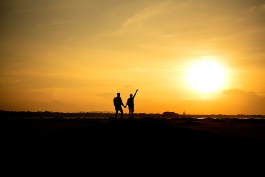 Silhouette traveler couples walking  on mountain at sunset times