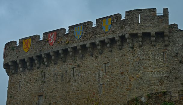 Stone wall with shields at fortress in Avranches, France