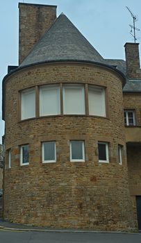 Stone rounded house tower with windows