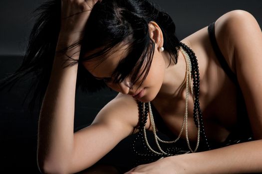Young beautiful woman in a fashionable clothing on a studio background