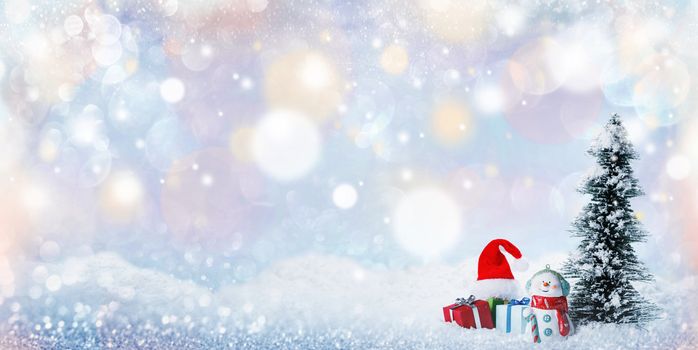 Snowman fir tree and christmas gifts on sleigh on snow, falling snow bokeh background