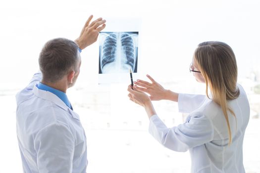 Doctors look and discuss x-ray in a clinic or hospital