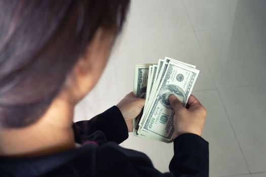 woman taking out money dollar banknotes from wallet