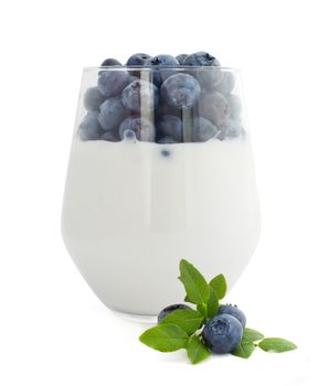 Yogurt and fresh berries blueberries studio isolated on white background
