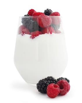 Yogurt and fresh berries raspberry and blackberry studio isolated on white background