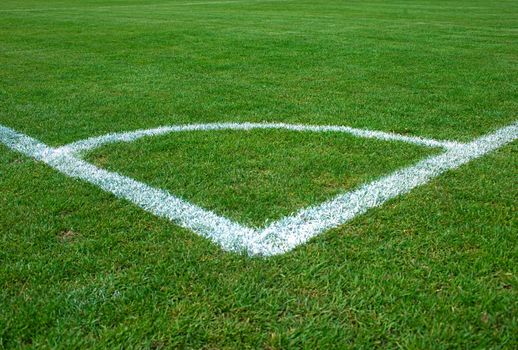 White corner lines on empty soccer grass field