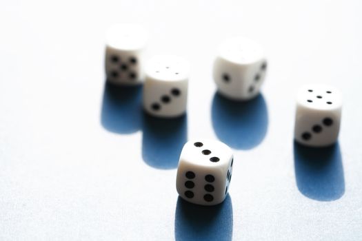 Few dice cubes on blue background with free space