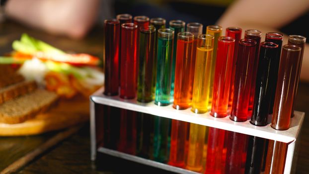 Test tubes with multi-colored liquid. Alcohol in test tubes dark bar. Photo from the bar in Lviv Ukraine