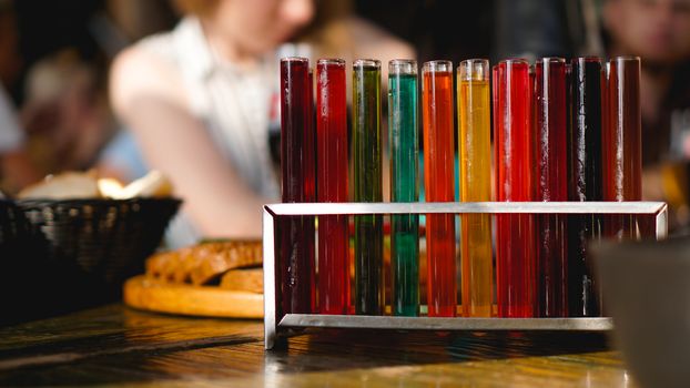 Test tubes with multi-colored liquid. Alcohol in test tubes dark bar. Photo from the bar in Lviv Ukraine