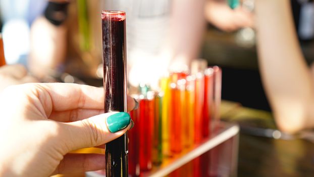 Test tubes with multi-colored liquid. Alcohol in test tubes dark bar. Photo from the bar in Lviv Ukraine