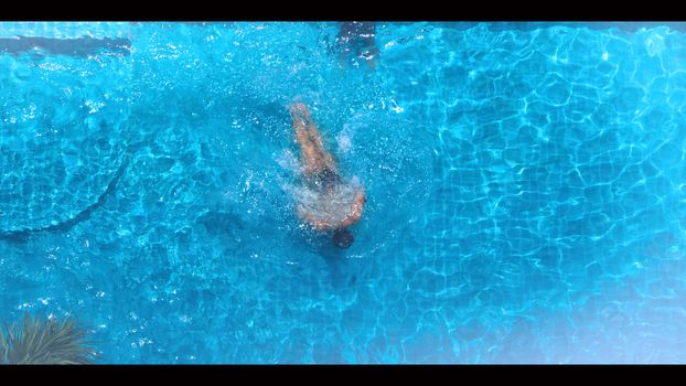 Swimming pool top view angle which blue color clear water and sun light reflect on surface texture and concept images for relaxation or vacation or sport in the tropical summer and for healthy lifestyle