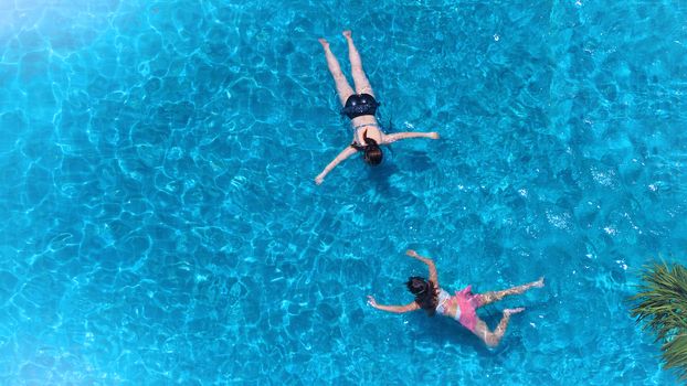 Swimming pool top view angle which blue color clear water and sun light reflect on surface texture and concept images for relaxation or vacation or sport in the tropical summer and for healthy lifestyle