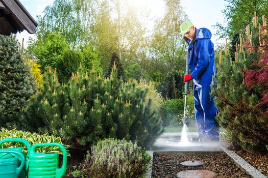 Men Washing Garden Paths Using Pressure Washing Machine. Backyard Cleaning Time.
