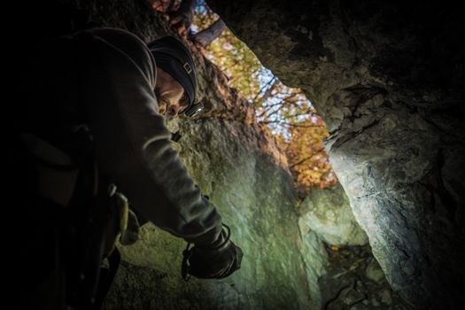 Caucasian Men in His 30s Exploring Beautiful Rock Formations and Caves. Lifestyle Theme.