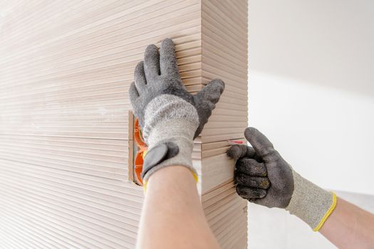 Modern Ceramic Tiles Installation Closeup Photo. Bathroom Remodeling Theme.