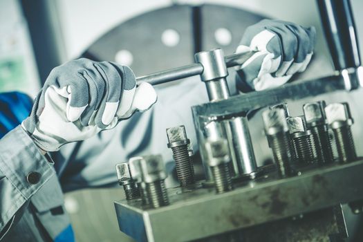 Metalworking Industry Worker Adjusting Lathe Machine. Industrial Theme.