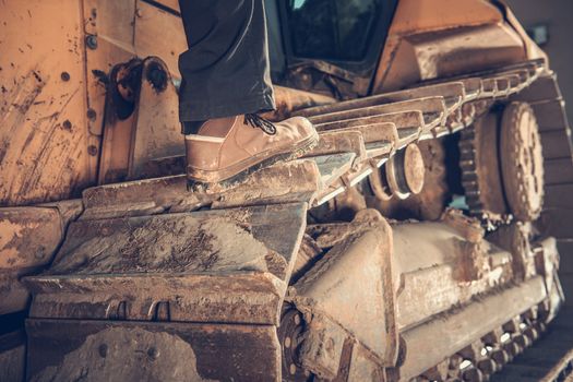 Heavy Duty Bulldozer Operator Concept Photo. Construction Equipment. Caterpillar Track Closeup.