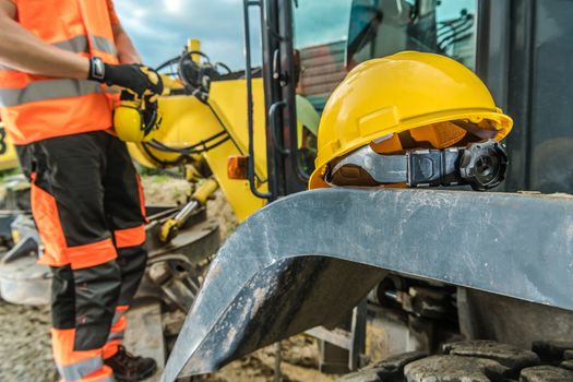 Hard Hat and Noise Reduction Headphones Worker Protection Concept Photo. Construction Industry.