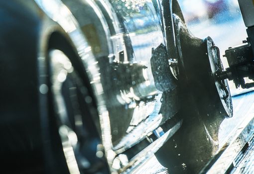 Automatic Car Wash Wheels Cleaning Brush in Action. Vehicle Cleaner.