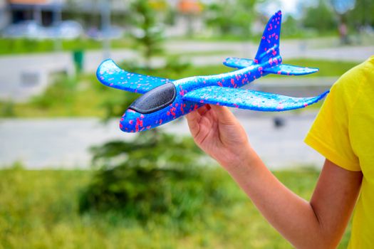 a child plays with a model airplane