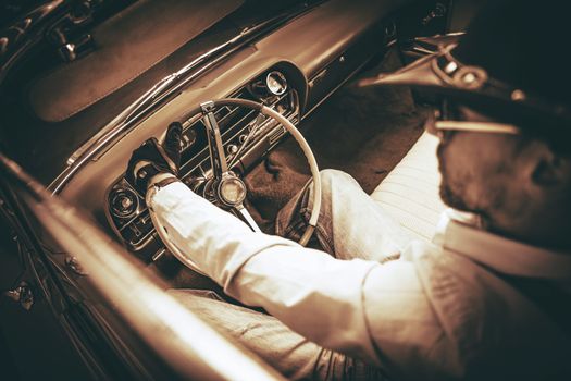 American Cowboy Driver in the Classic Convertible Car. Closeup Photo in Sepia Color Grading.