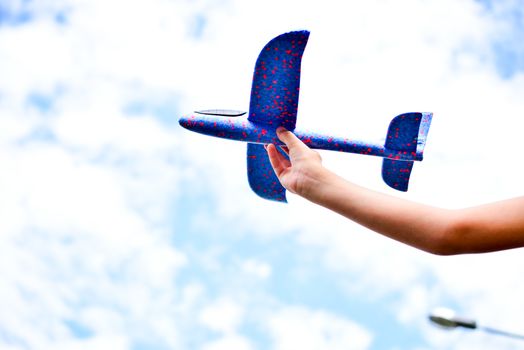 a child plays with a model airplane