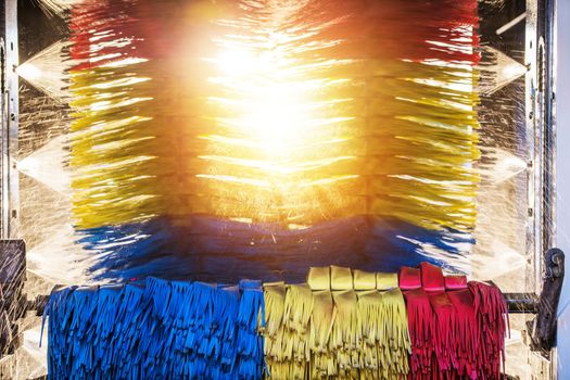 Sunny Automatic Car Wash. Spinning Colorful Brushes and the Sun in the Middle.