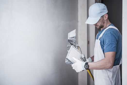 Caucasian Construction Worker in His 30s with Heavy Duty Grade Construction Lighting