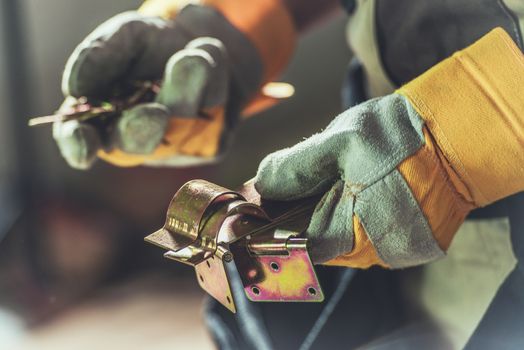 Choosing Right Hinge. Construction Worker with Metal Hinges in Hands.