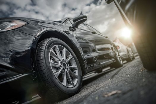 Full Cars Parking. Modern Vehicle Closeup from Low Ground Level. 