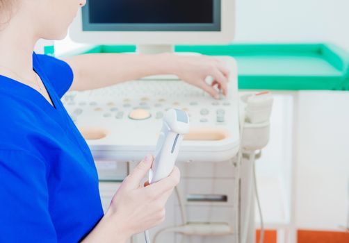 Ultrasonography Testing Equipment in Hand of Female Technician. Medical Theme.