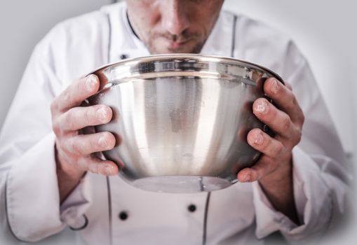 Kitchen Chef Cooking Time. Caucasian Chef with Stainless Steel Bowl in Hands During Food Preparation.