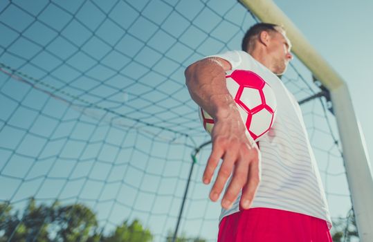 Caucasian Goalkeeper in His 30s with the Ball. Soccer Theme.