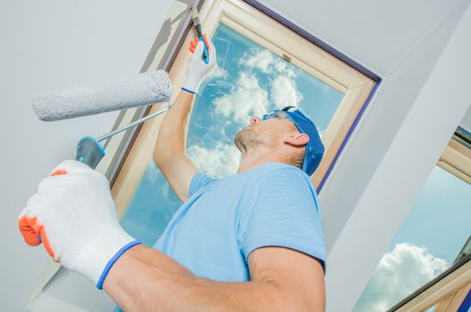 Painting Newly Constructed Home Walls. Caucasian Painter at Work.