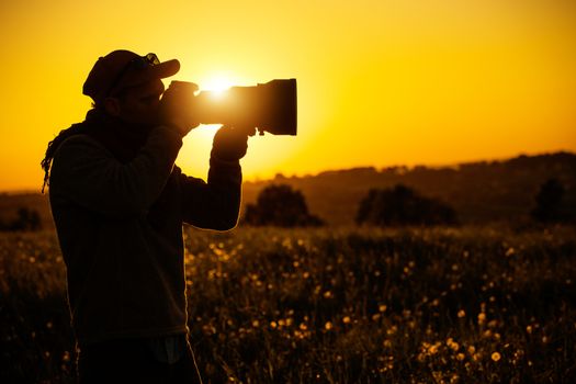 Passionate Outdoor Photographer. Scenic Sunset Silhouette. Modern Digital Photography Theme.