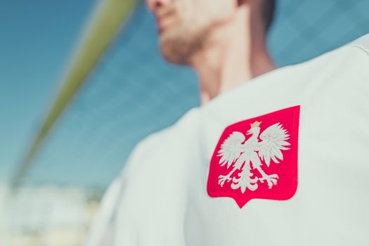 Polish Player with White Eagle National Emblem on the Tshirt. Closeup Photo. Polish National Team Player.